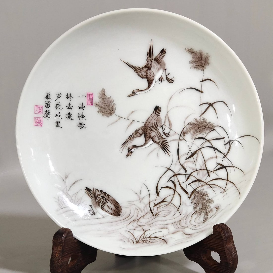 A Qing Dynasty Yongzheng period ink-painted plate with a design of reeds and geese and an inscriptio (1 of 7)
