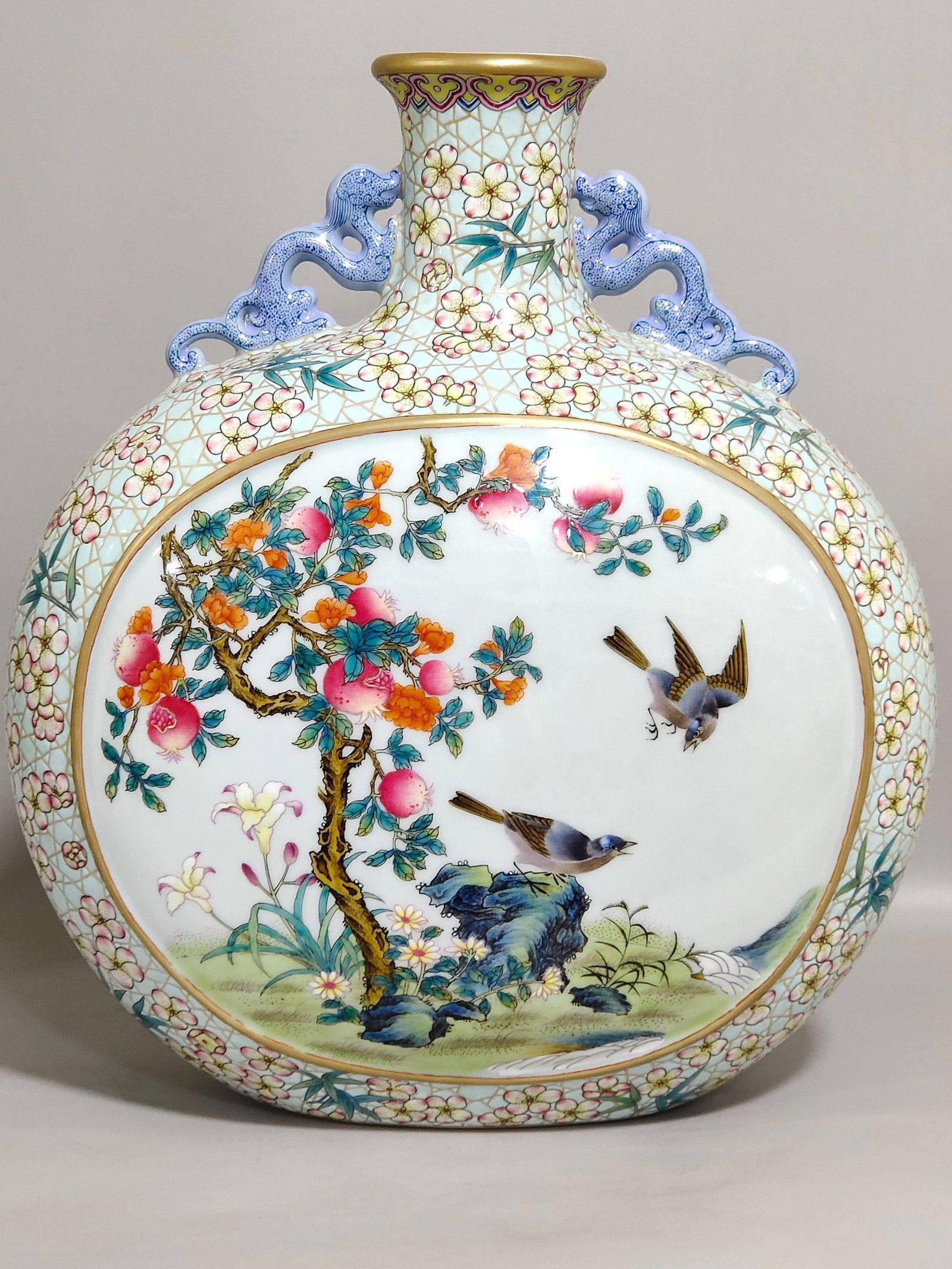 A Qing Dynasty Yongzheng period turquoise plum blossom and bird-shaped moon flask: A Qing Dynasty Yongzheng period turquoise plum blossom and bird-shaped moon flask, 29.5 cm high and 26.5 cm in diameter.