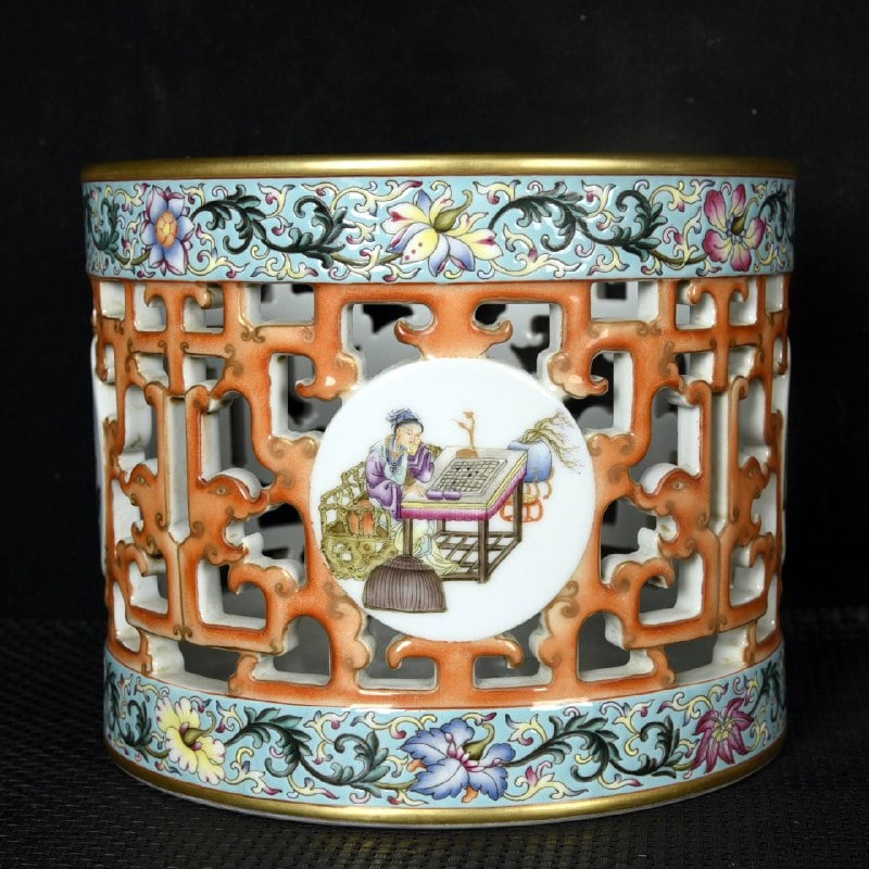 A Qing Dynasty Qianlong period enamel-painted and gilded openwork brush pot: A Qing Dynasty Qianlong period enamel-painted and gilded openwork brush pot with a design of the zither, chess, calligraphy, and painting. Height: 15.8 cm; Diameter: 19 cm.