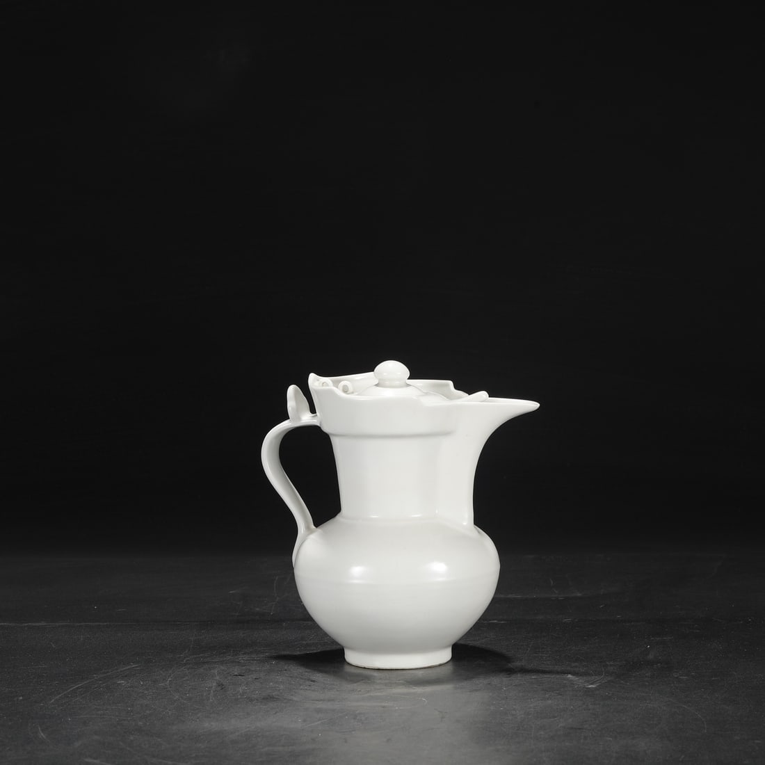 A Ming Dynasty Yongle period sweet-white glazed ewer with incised "Three Abundances" design.: Dimensions: Height 21 cm, Mouth diameter 8.5 cm, Diameter 19 cm.