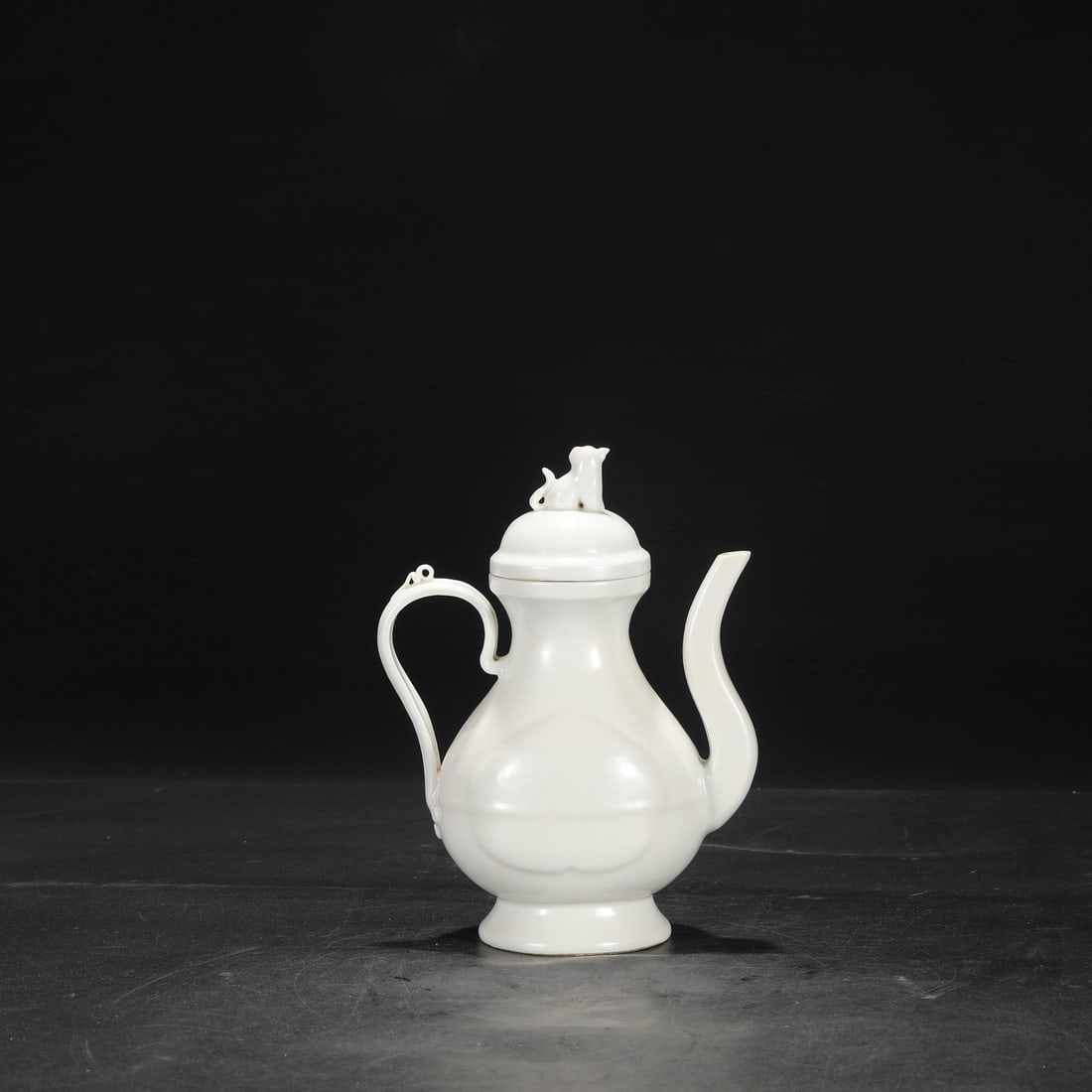 A Ming Dynasty Yongle period sweet-white glazed imperial ewer with incised floral design.: Dimensions: Height 22.5 cm, Mouth diameter 7 cm, Diameter 16 cm.