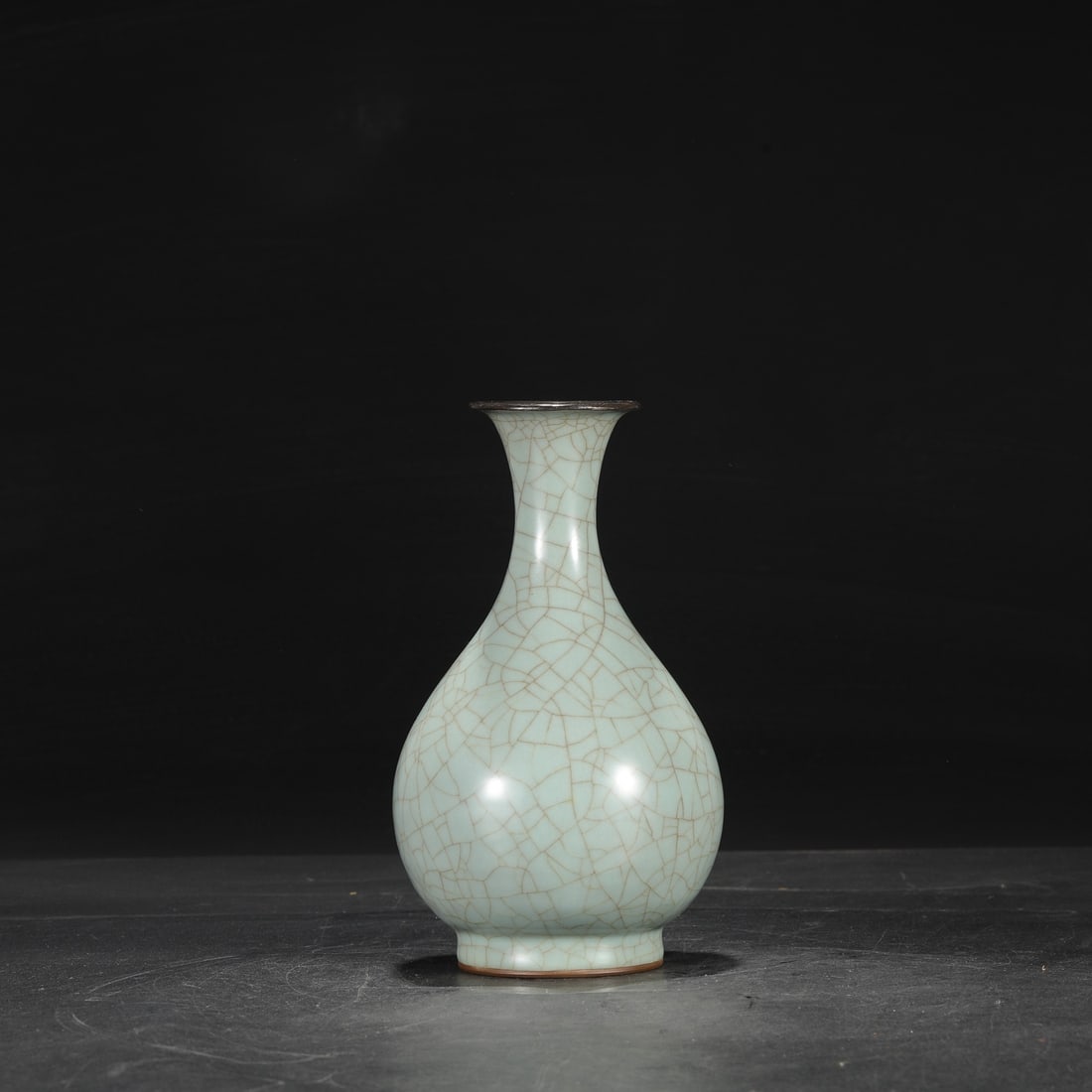 A Southern Song Dynasty official kiln celadon vase with a silver rim, used in the imperial court,: Dimensions: Height 23 cm, Mouth diameter 7 cm, Belly diameter 12 cm.