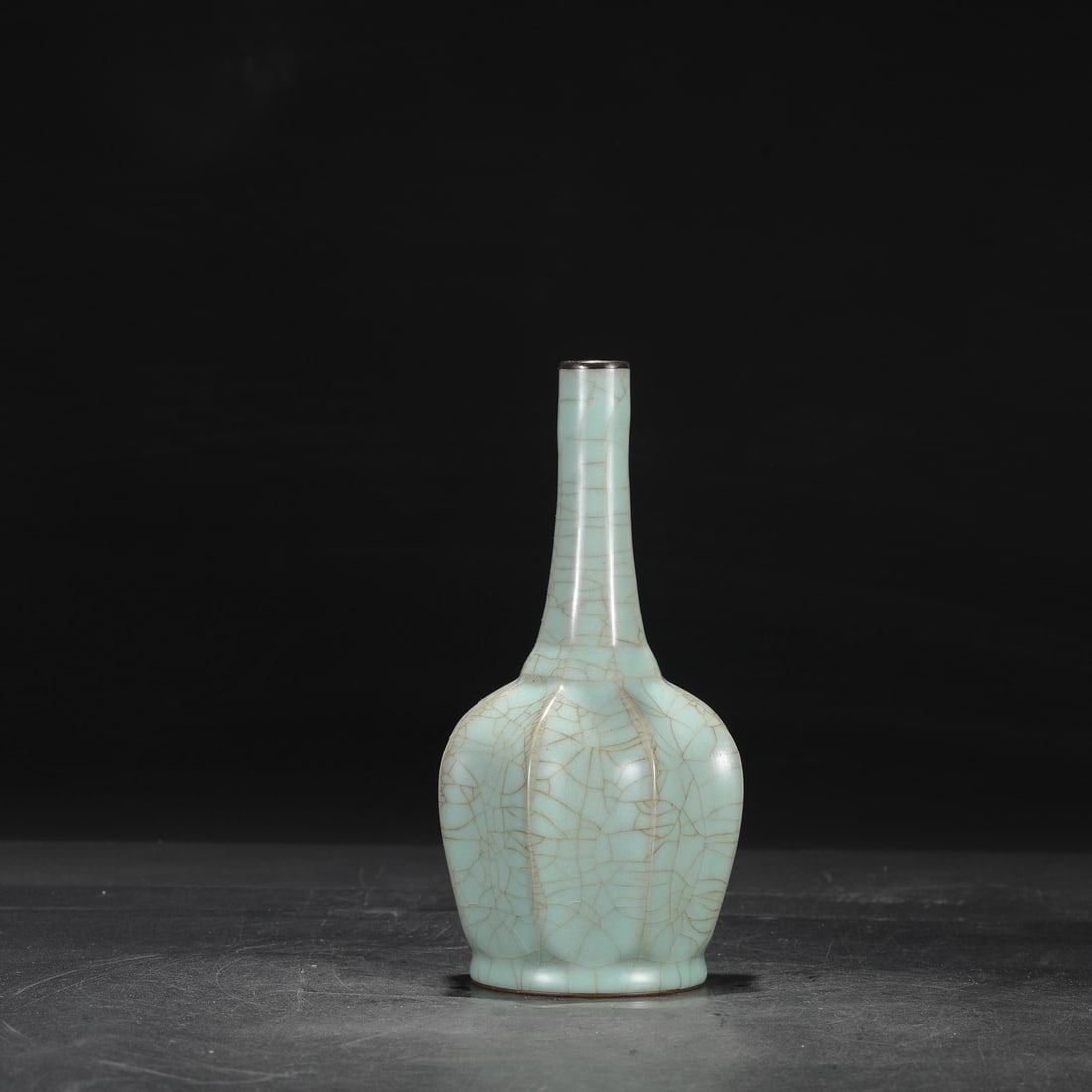 A Southern Song Dynasty official kiln celadon octagonal vase with a silver rim, formerly in the: Dimensions: Height 24 cm, Mouth diameter 2.5 cm, Belly diameter 11 cm.
