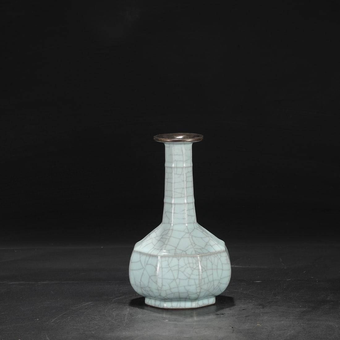 A Southern Song Dynasty official kiln celadon vase with a silver rim, used in the imperial court,: Dimensions: Height 25 cm, Mouth diameter 7 cm, Belly diameter 14.5 cm.