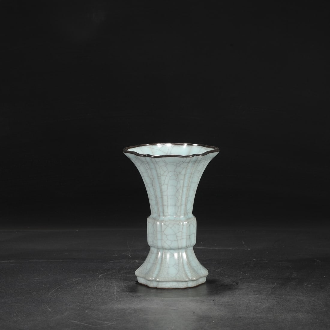 A Southern Song Dynasty official kiln celadon glaze with a silver rim, used in the imperial court,: Dimensions: Height 22 cm, Mouth diameter 15 cm, Belly diameter 7.5 cm.