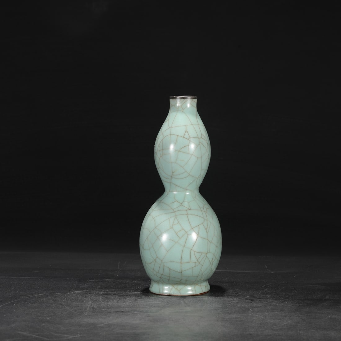 A Southern Song Dynasty official kiln celadon gourd-shaped vase with a silver rim, formerly in the (1 of 8)