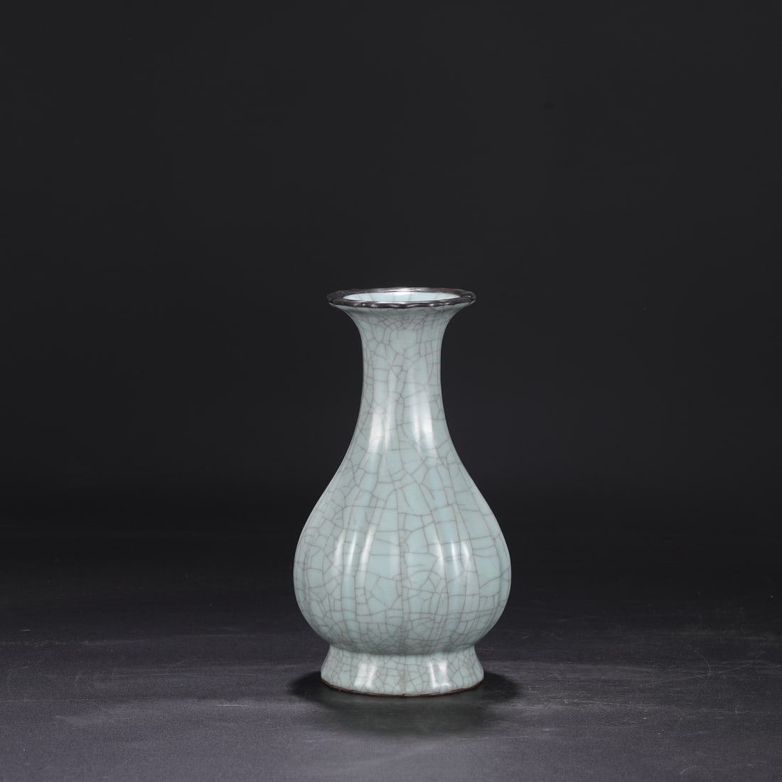 A Southern Song Dynasty official kiln celadon-glazed, silver-rimmed, imperial melon-shaped: Dimensions: Height 25 cm, Mouth diameter 9 cm, Belly diameter 13.5 cm.