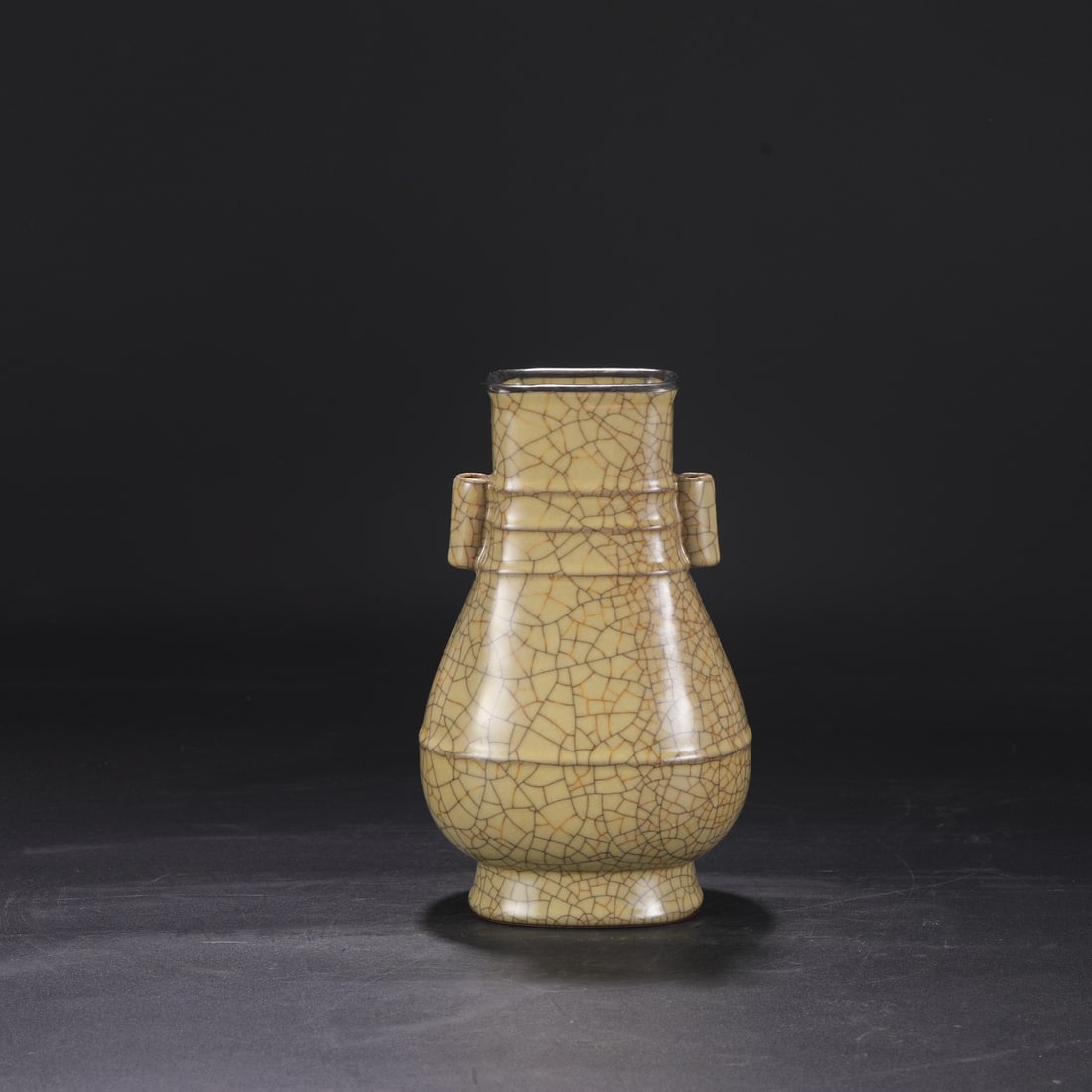 A Northern Song Dynasty Ge ware vase with a beige glaze, silver rim, and imperial handles, formerly: Dimensions: Height 24 cm, Mouth diameter 8.5 cm, Belly diameter 13.5 cm.