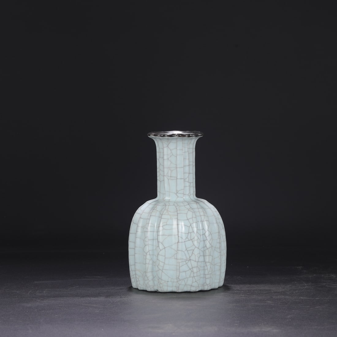 A Southern Song Dynasty official kiln celadon vase with a silver rim, used in the imperial court,: Dimensions: Height 24 cm, Mouth diameter 8 cm, Belly diameter 13 cm.