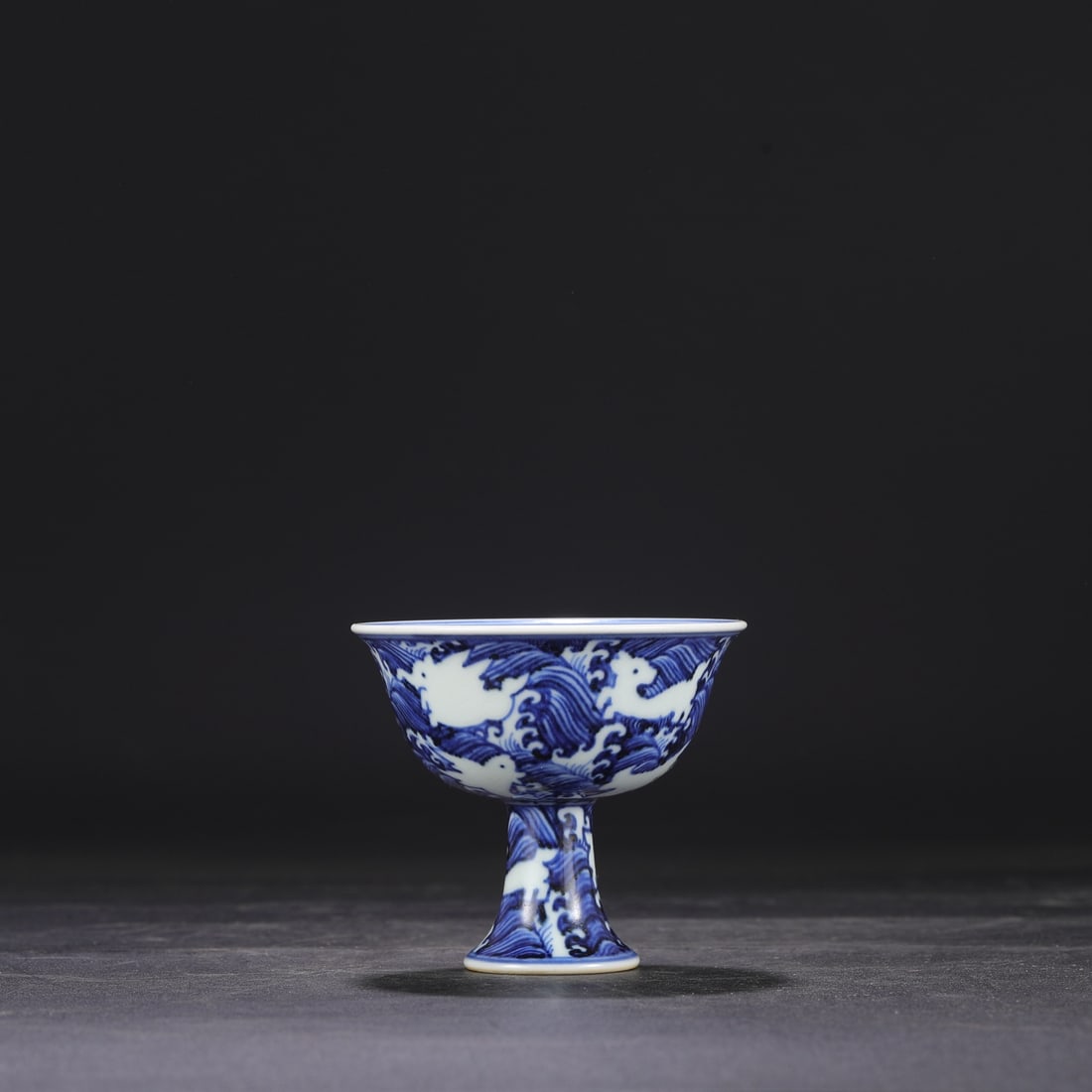 Formerly in the collection, a Ming Dynasty Xuande blue and white porcelain stem cup with a design of (1 of 7)