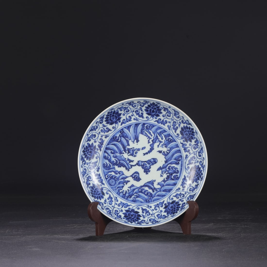 A large blue-and-white porcelain dish with a dragon design amidst waves, dating from the Xuande (1 of 8)