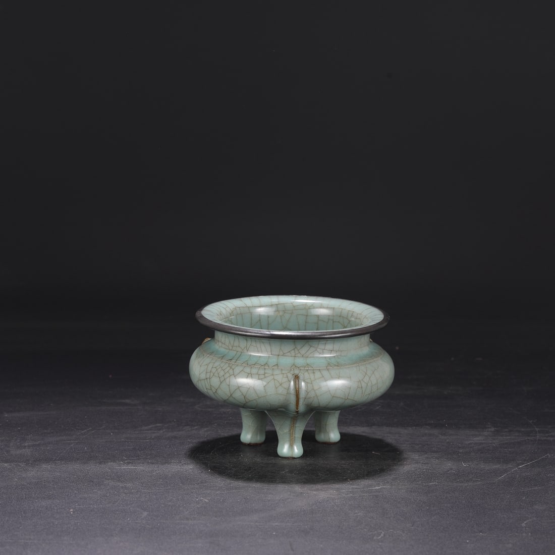 A Southern Song Dynasty official kiln celadon censer with silver rim, used in the imperial court,: Dimensions: Height 11 cm, Mouth diameter 14 cm, Belly diameter 15 cm.