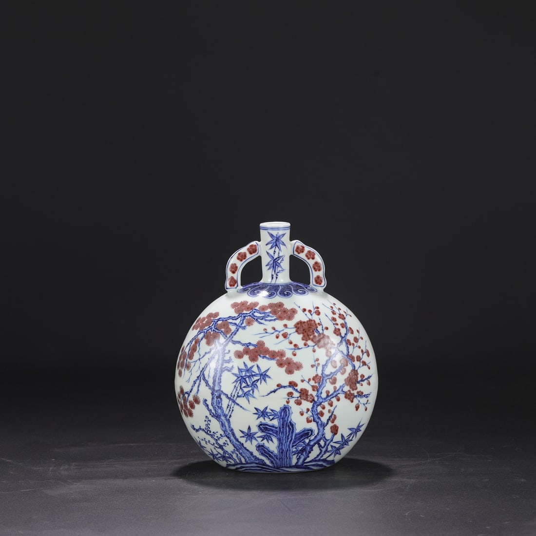 A Ming Dynasty Yongle period blue and white underglaze red moon flask with pine, bamboo and plum (1 of 8)