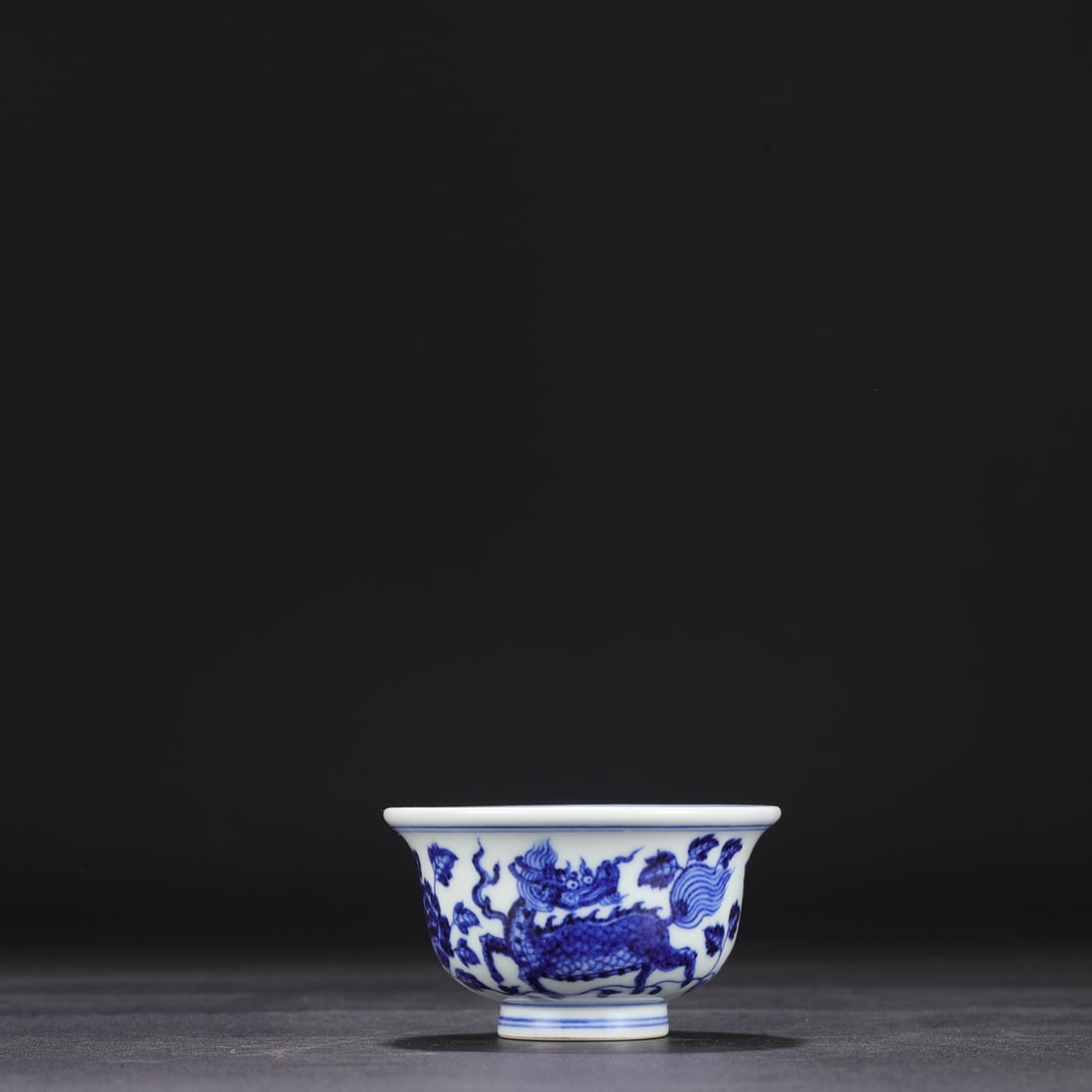 The Ming Dynasty Xuande blue and white porcelain cup with a qilin design, formerly in the (1 of 8)