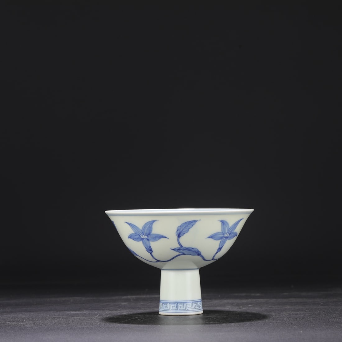 A Ming Dynasty Chenghua blue and white porcelain stem bowl with a scrolling floral design, formerly (1 of 7)