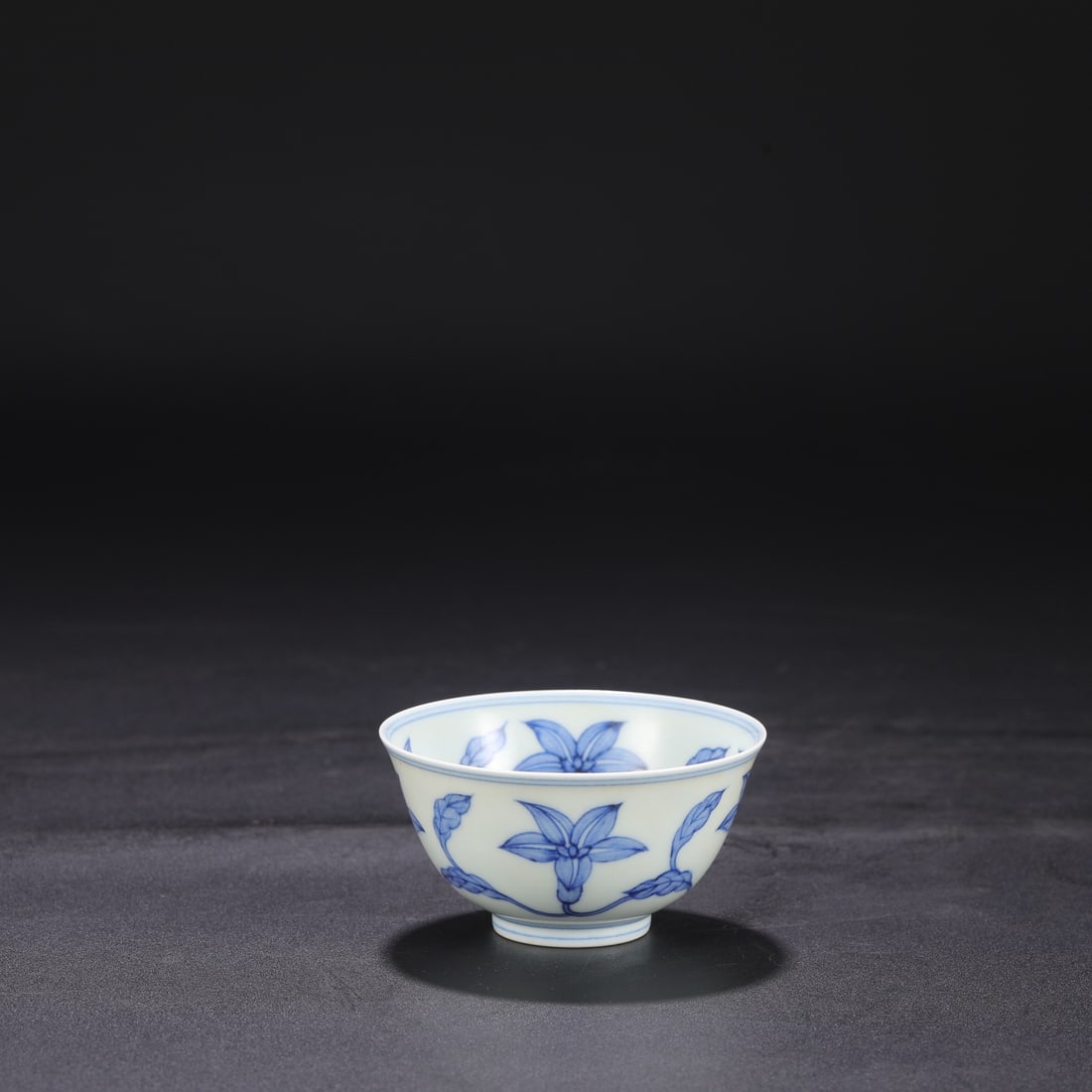 The Ming Dynasty Chenghua blue and white porcelain cup with a scrolling floral design, formerly in (1 of 6)