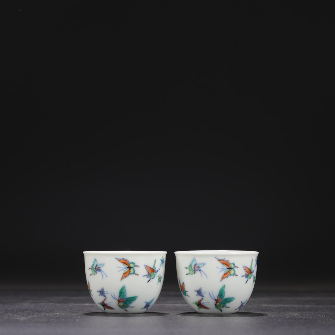 A pair of Qing Dynasty Yongzheng Doucai cups with butterfly design.: Dimensions: Height 4 cm, Mouth diameter 5.5 cm.