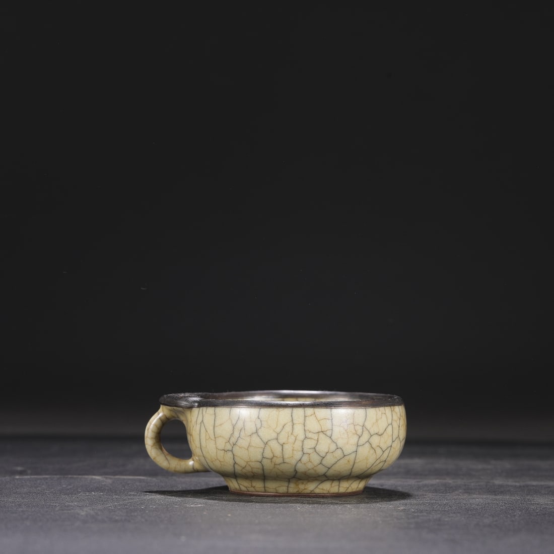 A Northern Song Dynasty Ge ware cup with a beige glaze and silver handle, formerly from a: Dimensions: Height 4 cm, Mouth Diameter 8 cm.