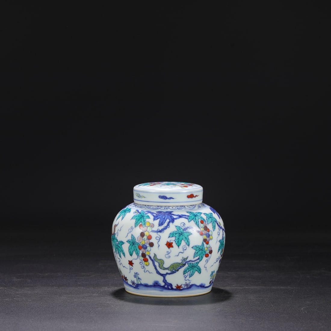 A Ming Dynasty Chenghua period doucai (enamel overglaze enamel) covered jar with squirrel and grape: Dimensions: Height 14.5 cm, Mouth diameter 7 cm, Belly diameter 14.5 cm.