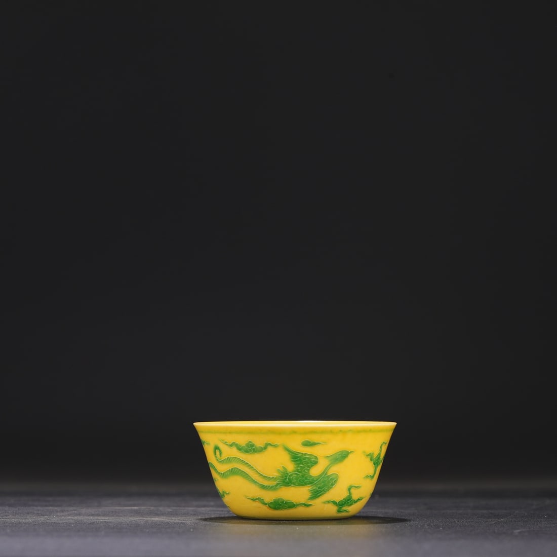 A Ming Dynasty Chenghua period yellow-ground green-enamel cloud and phoenix pattern cup, formerly in (1 of 6)