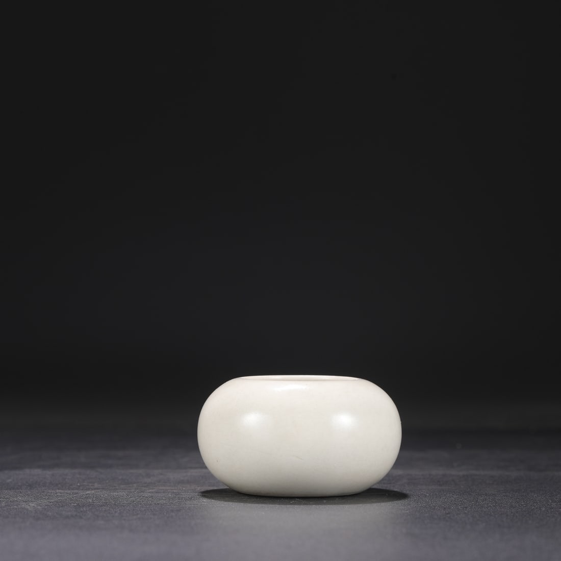 A small white-glazed bowl from the Xing kiln of the Tang Dynasty, formerly in the collection.: Dimensions: Height 4.5 cm, Mouth diameter 4 cm, Belly diameter 7.5 cm.