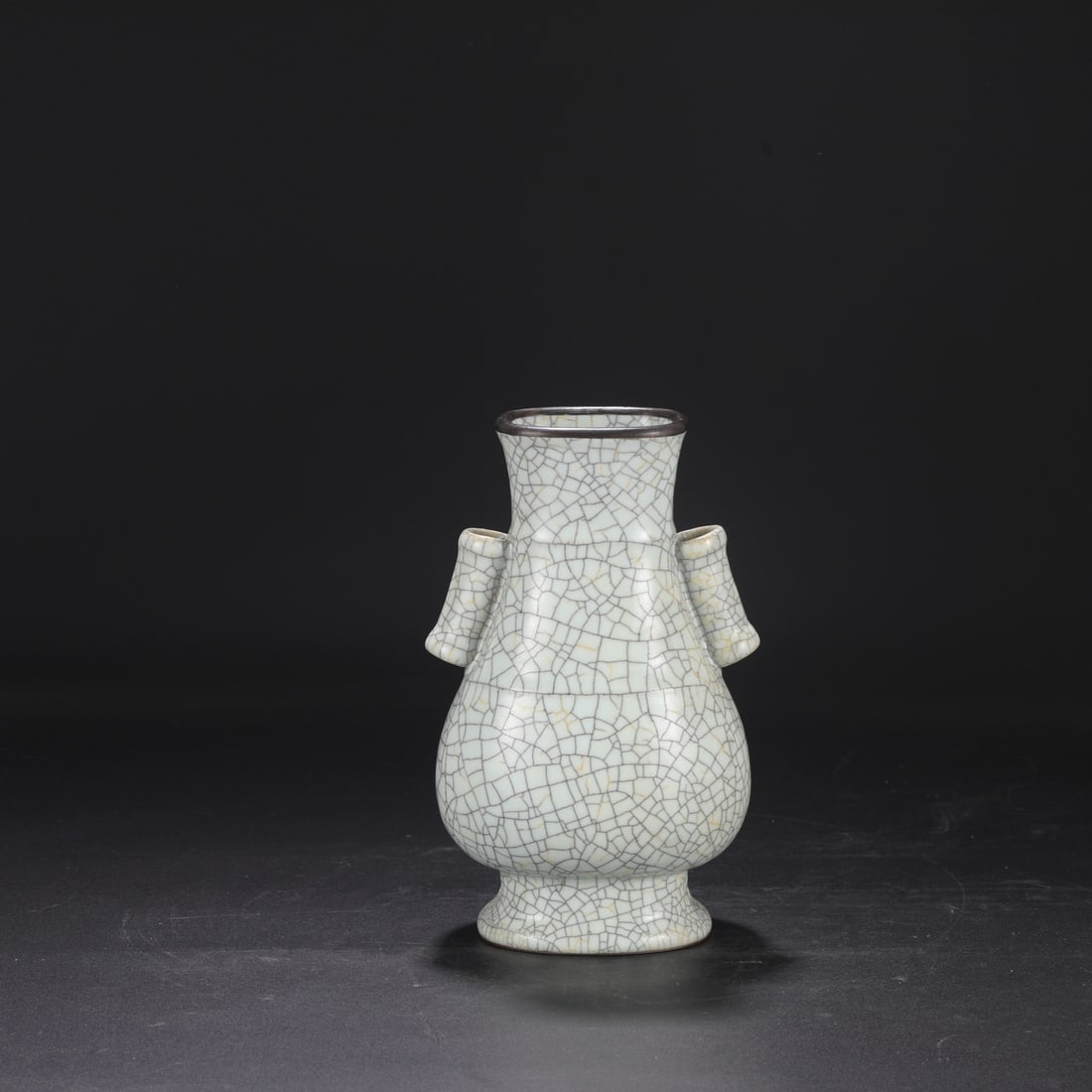 A Northern Song Dynasty Ge ware vase with a creamy white glaze, silver rim, and imperial handles,: Dimensions: Height 25 cm, Mouth diameter 9 cm, Belly diameter 15 cm.