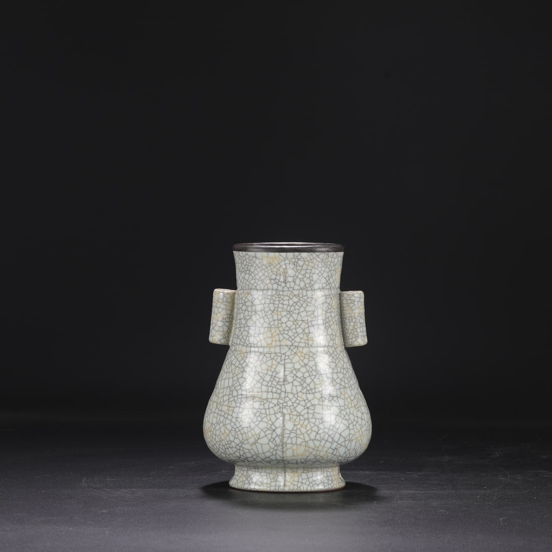 A Northern Song Dynasty Ge ware vase with a creamy white glaze, silver rim, and imperial handles,: Dimensions: Height 23 cm, Mouth diameter 10 cm, Belly diameter 14.5 cm.