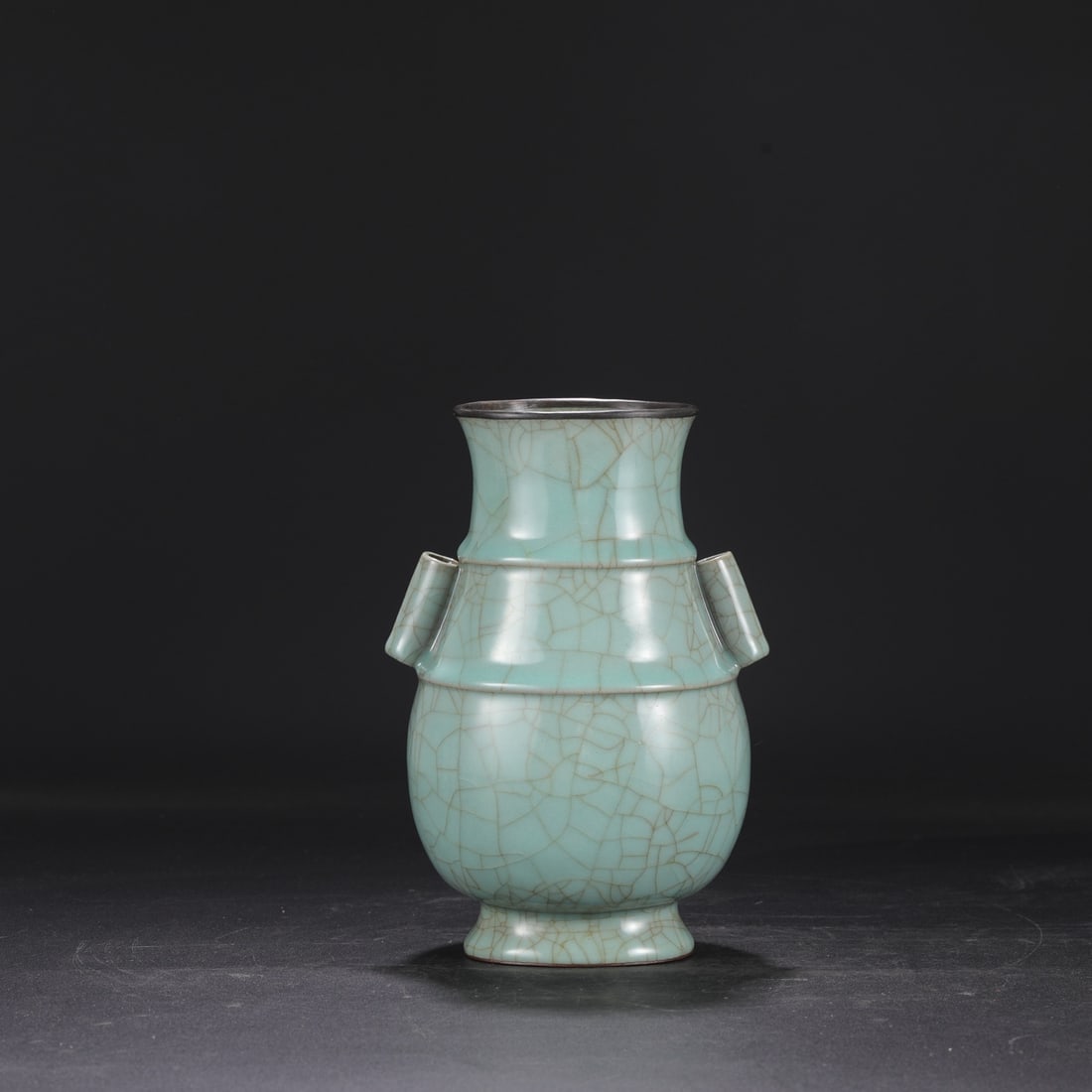 A Southern Song Dynasty official kiln celadon vase with a silver rim, used in the imperial court,: Dimensions: Height 23 cm, Mouth diameter 10 cm, Diameter 15 cm.