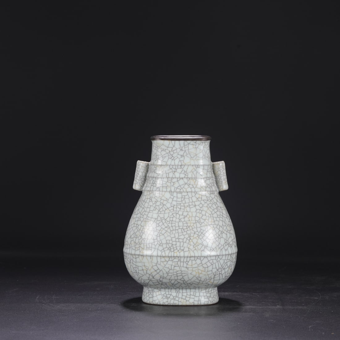 A Northern Song Dynasty Ge ware vase with a creamy white glaze, silver rim, and imperial handles,: Dimensions: Height 24 cm, Mouth diameter 8 cm, Belly diameter 15 cm.