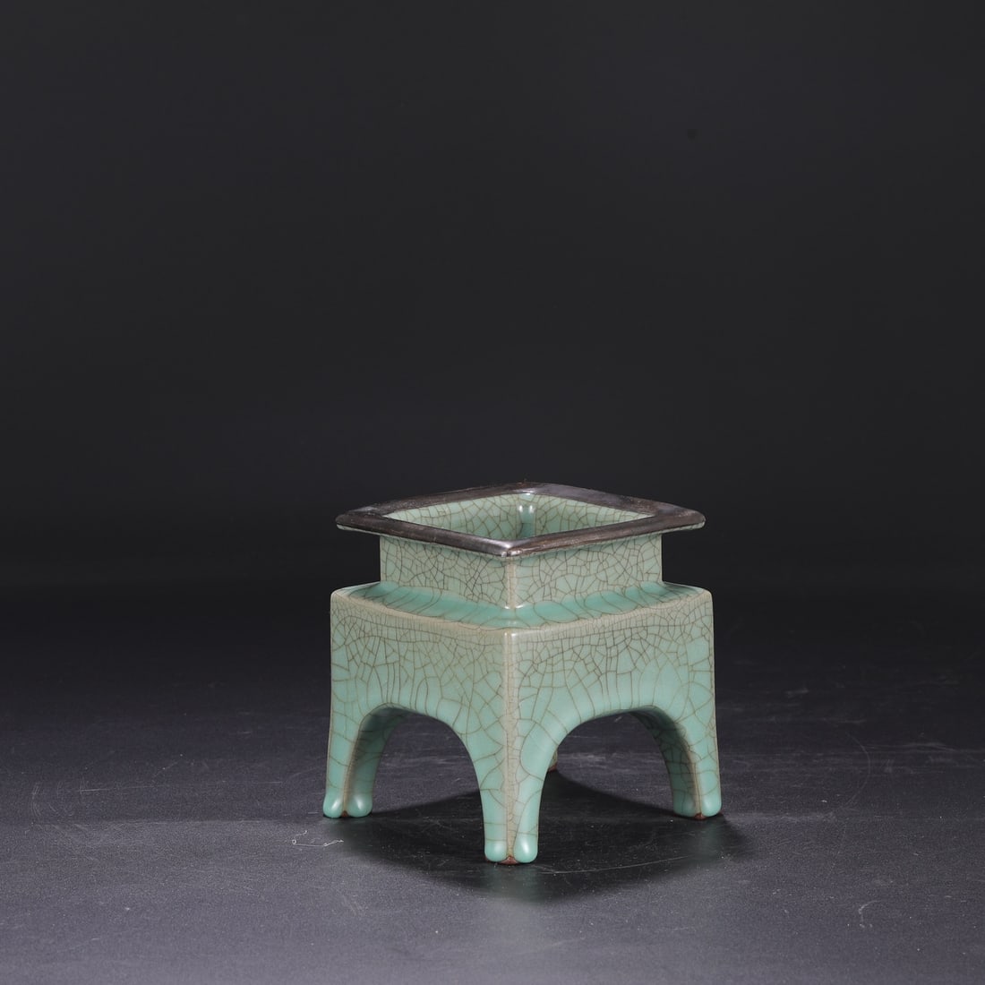 A Southern Song Dynasty official kiln celadon-glazed silver-rimmed square tripod-shaped incense: Dimensions: Height 15 cm, Mouth Diameter 17.5 cm.
