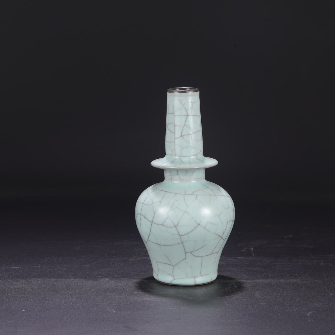 A Southern Song Dynasty official kiln celadon vase with a silver rim, used in the imperial court and: Dimensions: Height 23.5 cm, Mouth diameter 4 cm, Belly diameter 12 cm.
