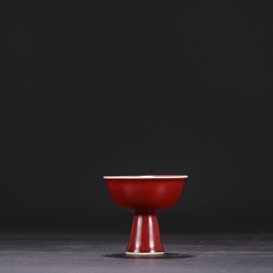 A Ming Dynasty Xuande period gem-red glazed stem cup, formerly in the collection. (1 of 7)