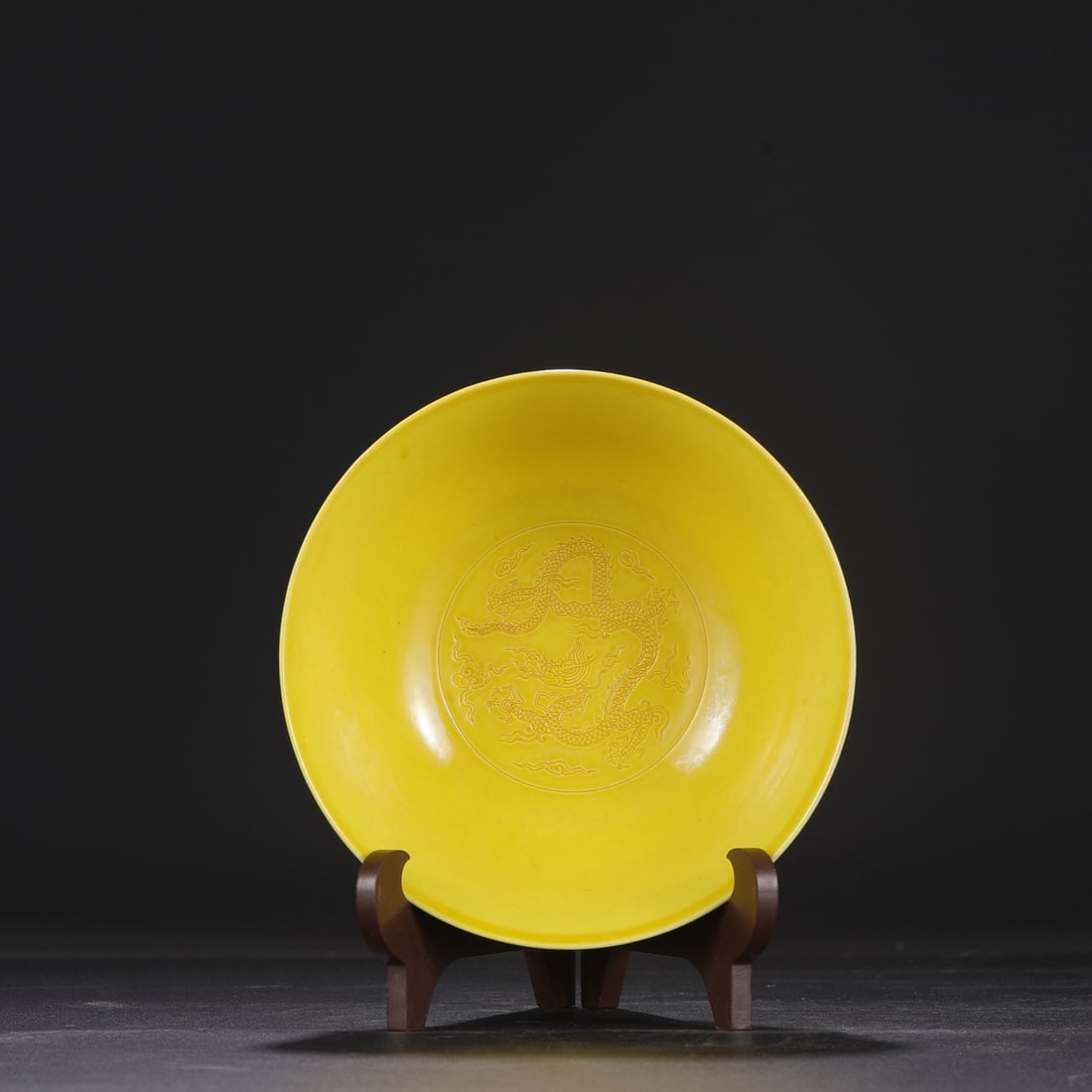 A large, deep-bodied bowl with a yellow ground and red glaze, decorated with incised dragon and sea (1 of 8)