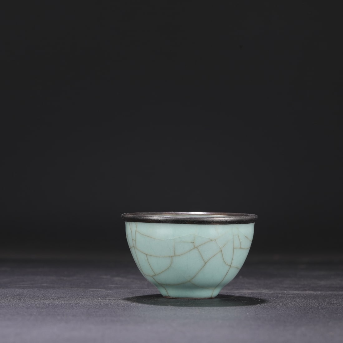 A Southern Song Dynasty official kiln celadon ware Luohan cup with a silver rim, formerly in the (1 of 7)