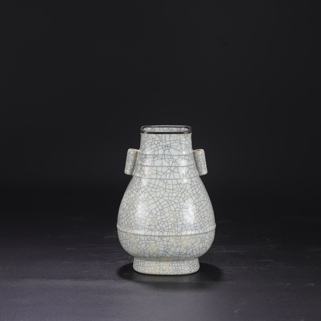 A Northern Song Dynasty Ge ware vase with a creamy white glaze, silver rim, and imperial handles,: Dimensions: Height 24 cm, Mouth diameter 8 cm, Belly diameter 15 cm.