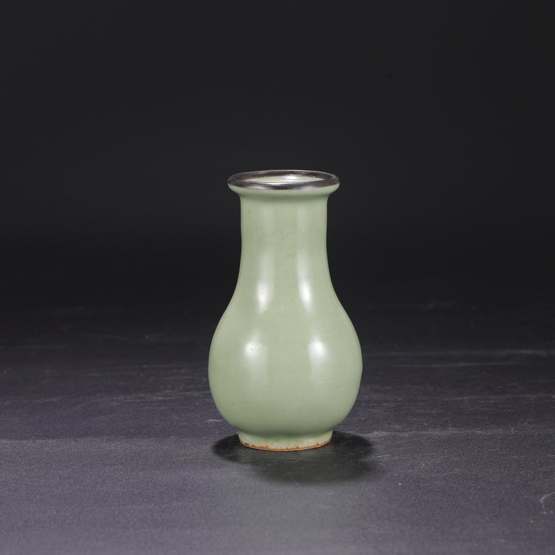 A Southern Song Dynasty Longquan celadon vase with silver rim and string pattern, formerly in the: Dimensions: Height 15.5 cm, Mouth diameter 6 cm, Belly diameter 8 cm.