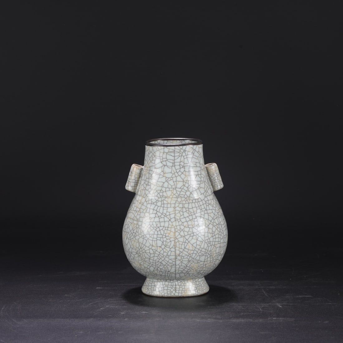 A Northern Song Dynasty Ge ware vase with a creamy white glaze, silver rim, and imperial handles,: Dimensions: Height 23.5 cm, Mouth diameter 8 cm, Belly diameter 15 cm.