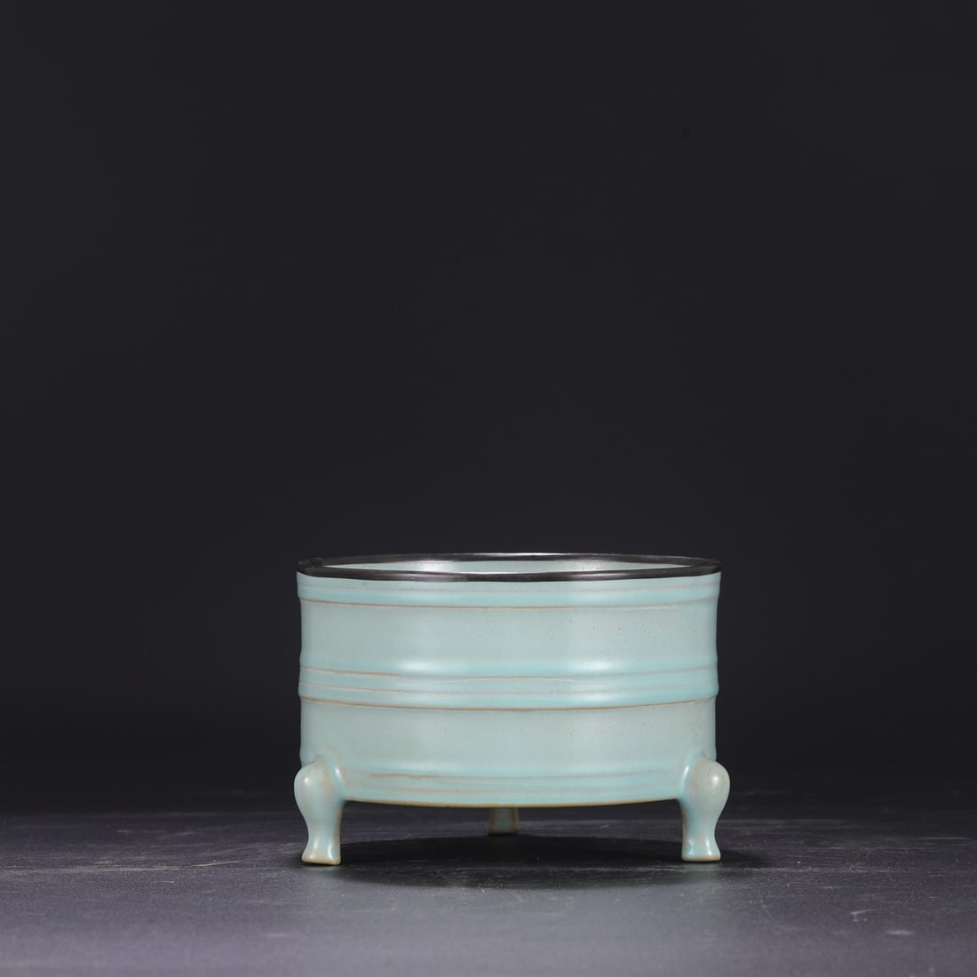 A Northern Song Dynasty Ru ware celadon-glazed, silver-rimmed, imperial court-used three-legged: Dimensions: Height 13 cm, Mouth Diameter 18 cm.