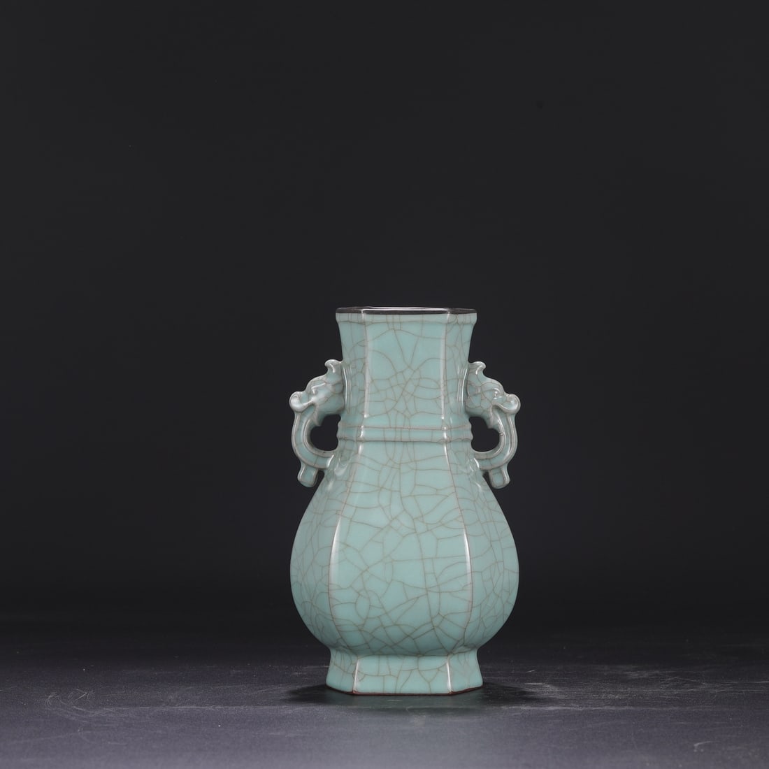 A Southern Song Dynasty official kiln celadon vase with silver rim and elephant-ear handles, bearing: Dimensions: Height 23.5 cm, Mouth diameter 8.5 cm, Belly diameter 13 cm.