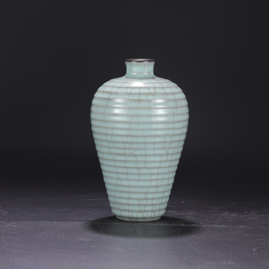 A large Southern Song Dynasty official kiln celadon plum vase with a silver rim, used in the: Dimensions: Height 23.5 cm, Mouth diameter 4 cm, Belly diameter 14 cm.