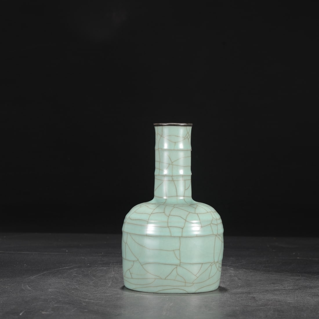 A Southern Song Dynasty official kiln celadon vase with a silver rim, used in the imperial court and: Dimensions: Height 22 cm, Mouth diameter 5 cm, Belly diameter 12.5 cm.