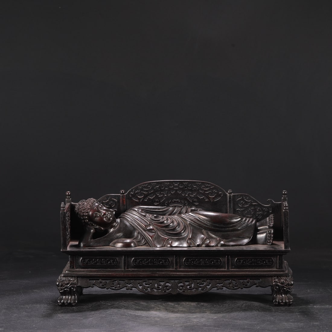 A large reclining Buddha made of rosewood from the Qianlong period of the Qing Dynasty, formerly in: Dimensions: Height 22 cm, Diameter 48 cm