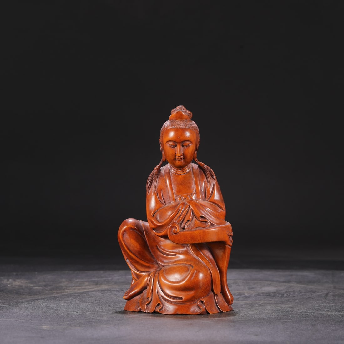 A Qing Dynasty Qianlong period boxwood carved seated figure, (1 of 7)