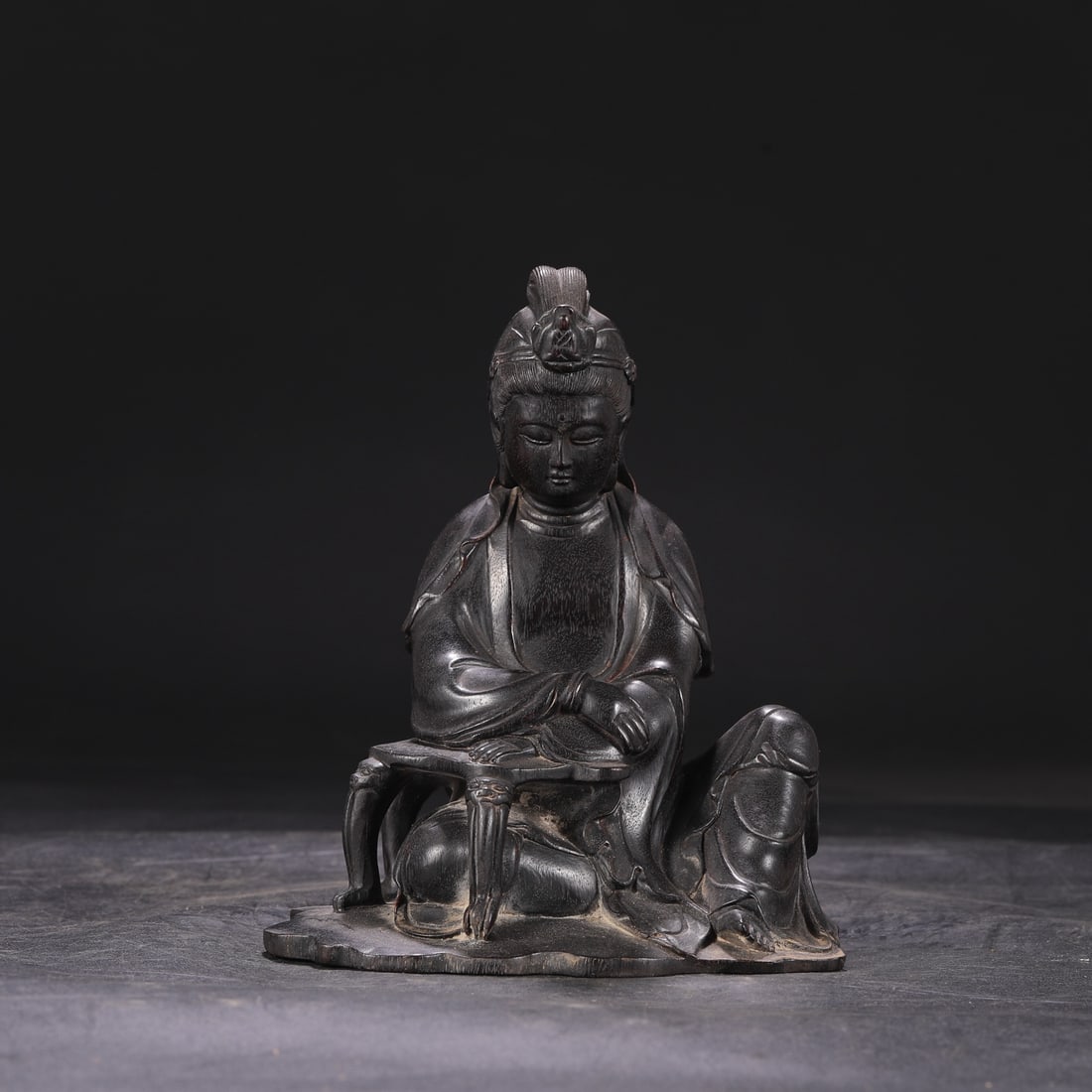 A Qing Dynasty Qianlong period seated Buddha statue made of rosewood, formerly in the collection.: Dimensions: Height 19.5 cm, Diameter 16 cm.