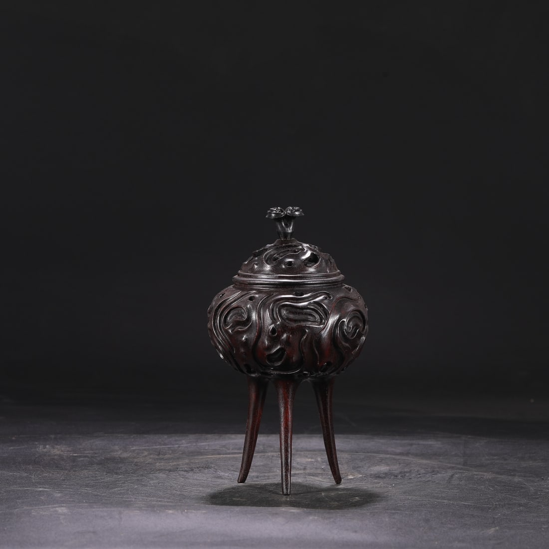 A Qing Dynasty Qianlong period (1736-1745) zitan wood carved openwork three-legged tripod-shaped (1 of 7)