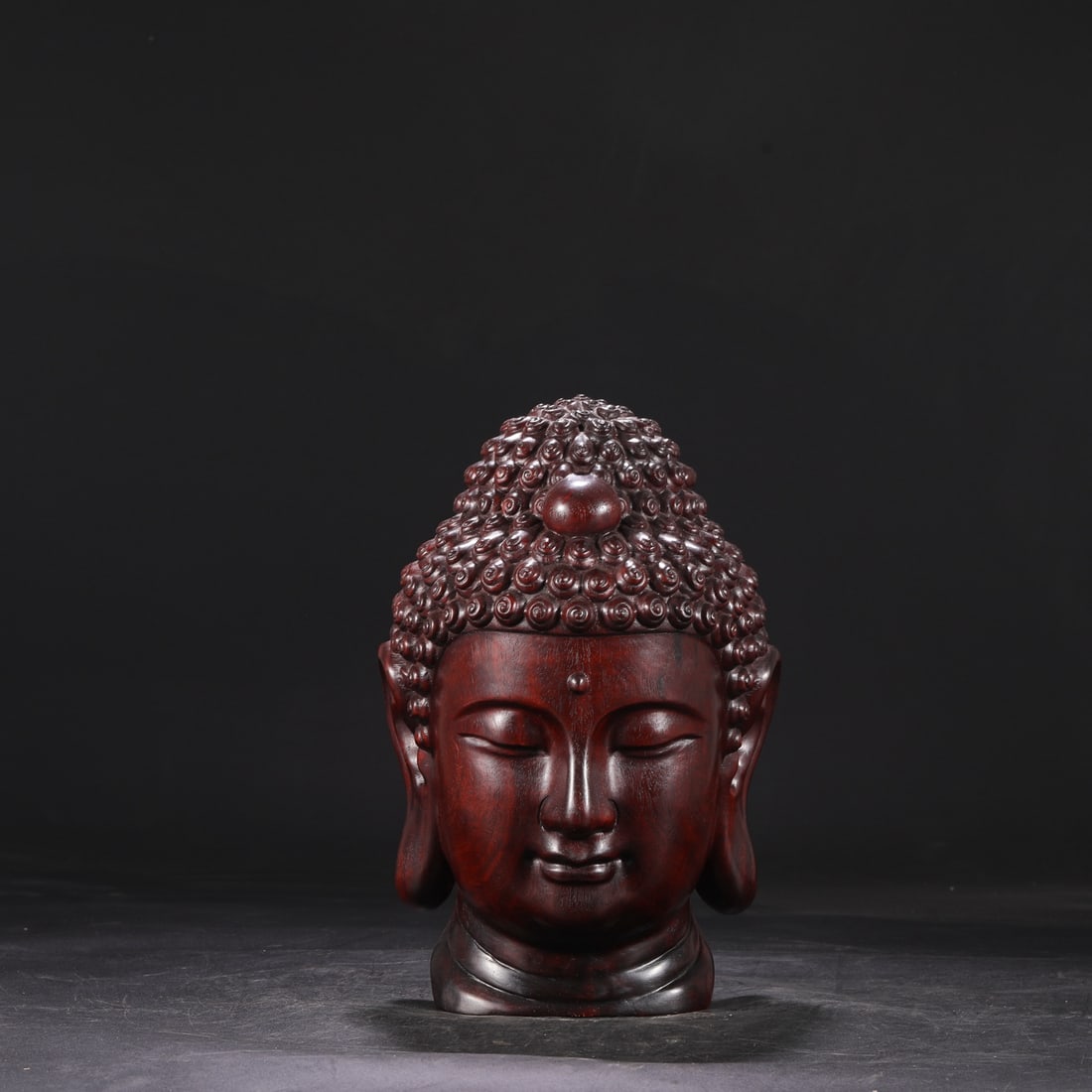 A Qing Dynasty Qianlong period huanghuali wood carved Buddha head, dimensions: (1 of 7)