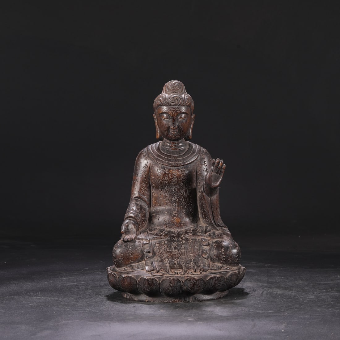 A Qing Dynasty Qianlong period sandalwood carved Buddhist scripture statue with a lotus petal base. (1 of 8)
