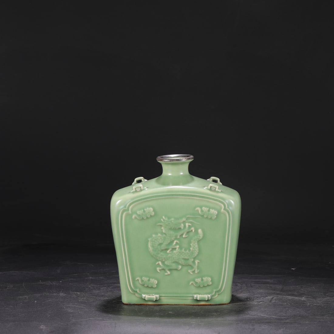 A Yuan Dynasty Longquan celadon flat bottle with a silver rim, openwork design, and four handles,: Dimensions: Height 24 cm, Mouth Diameter 6 cm, Diameter 21 cm.