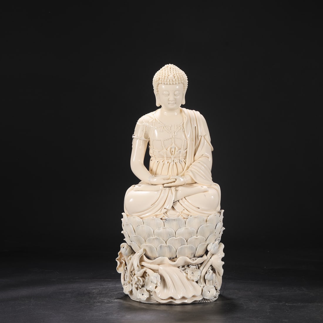 A Ming Dynasty Dehua kiln ivory-yellow glazed seated Buddha statue on a lotus petal base. (1 of 8)