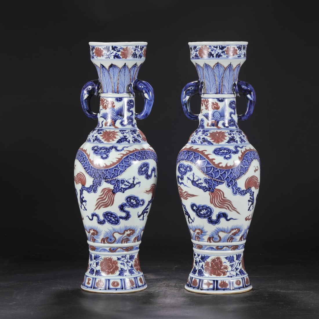 A pair of Yuan Dynasty blue-and-white underglaze red cloud and dragon pattern elephant-ear vases: Dimensions: Height 58 cm, Mouth diameter 14 cm, Belly diameter 18 cm.